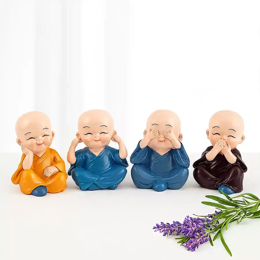 Set of four colorful Buddha monk figurines made of polyresin, each radiating positivity and tranquility.