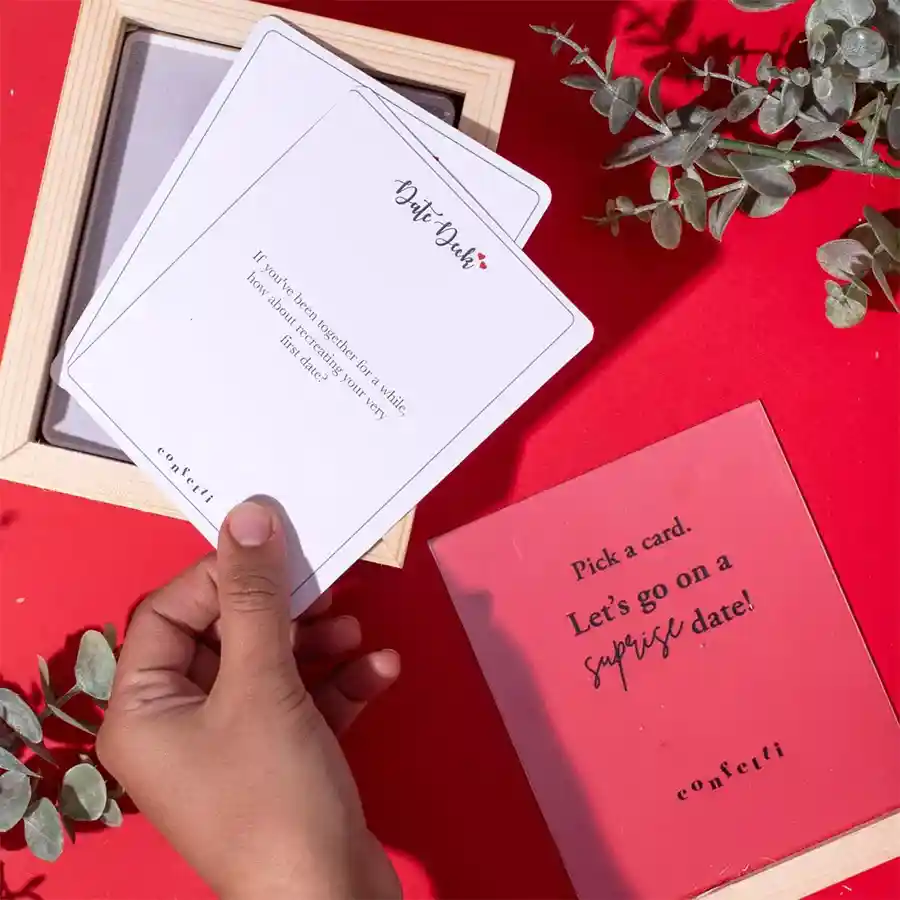 A beautifully designed deck of Love-Inspired Date Night Cards for couples, presented in an elegant wooden box with an acrylic slider lid.