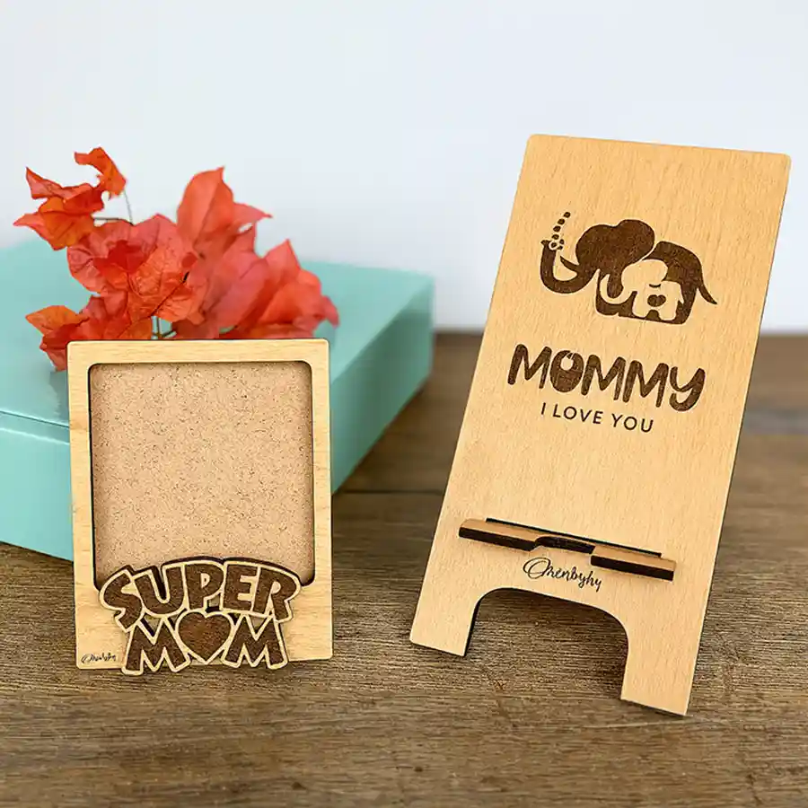 Gifts combo featuring Super Mom engraved Polaroid frames and a stylish mobile stand, celebrating mothers' love and strength.