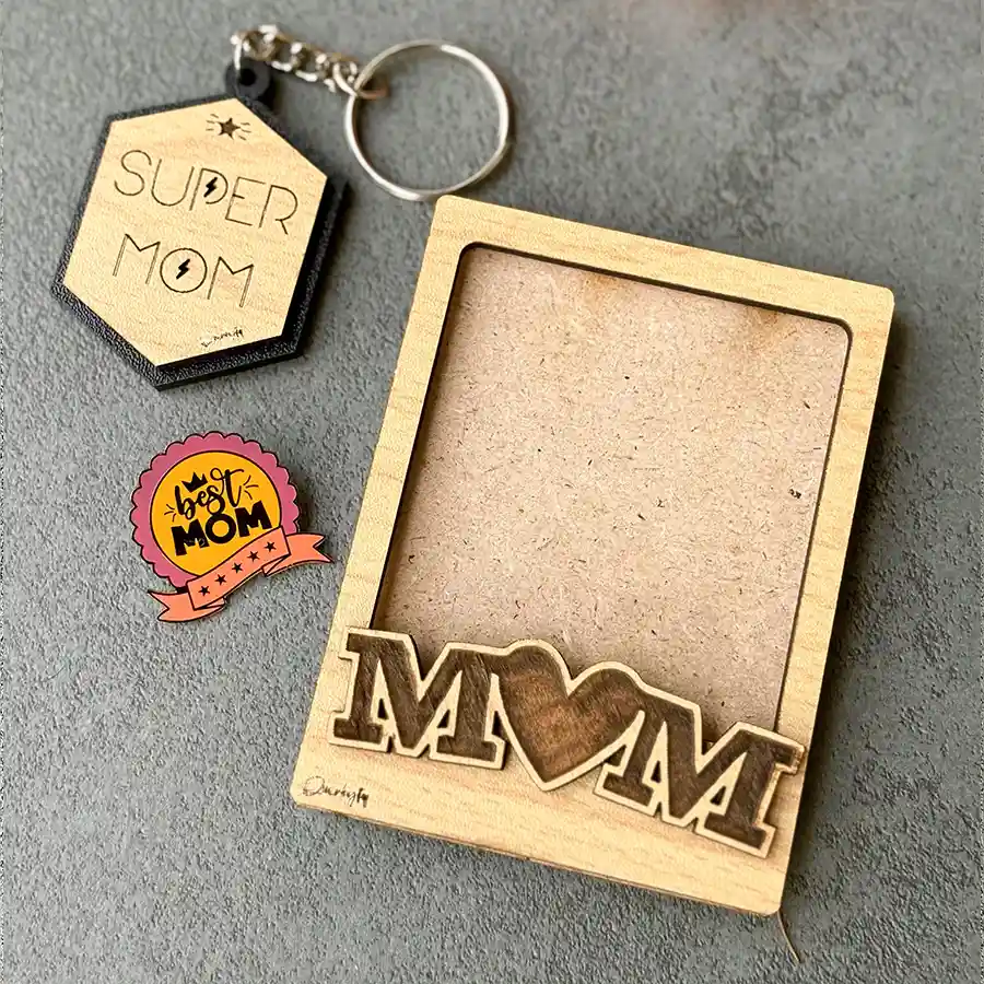 A heartfelt Mother's Day gift trio featuring a Super Mom Polaroid magnet frame, a pinewood MDF keychain, and a stylish lapel pin.