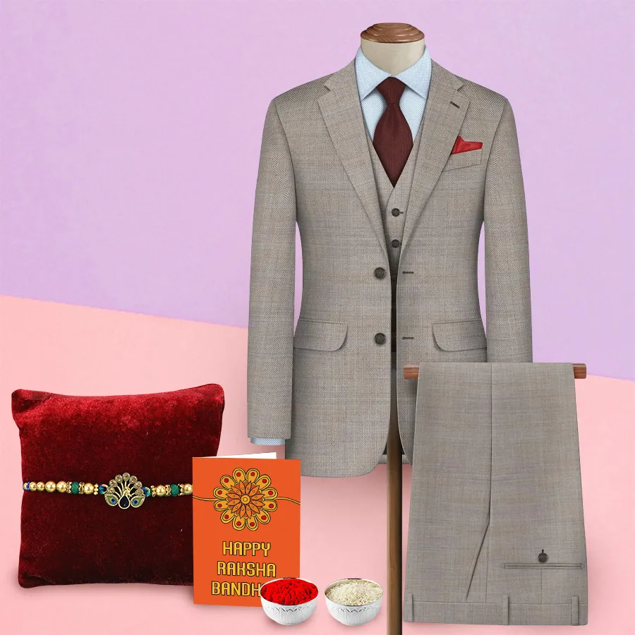 Suit length fabric from Raymonds with a Rakhi, Roli, Tilak, and Chawal set displayed together.