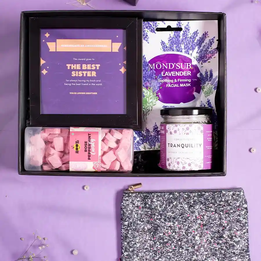 Trendy gift box for sisters featuring a best sister award frame, lavender bath salts, peppermint candy, and more, elegantly packaged.