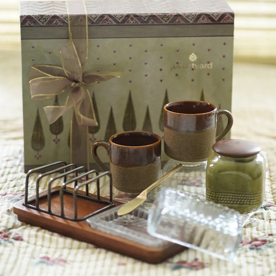 Morning Bliss Essentials Hamper featuring toast rack, cups, knife, and sugar pot for a delightful breakfast experience.