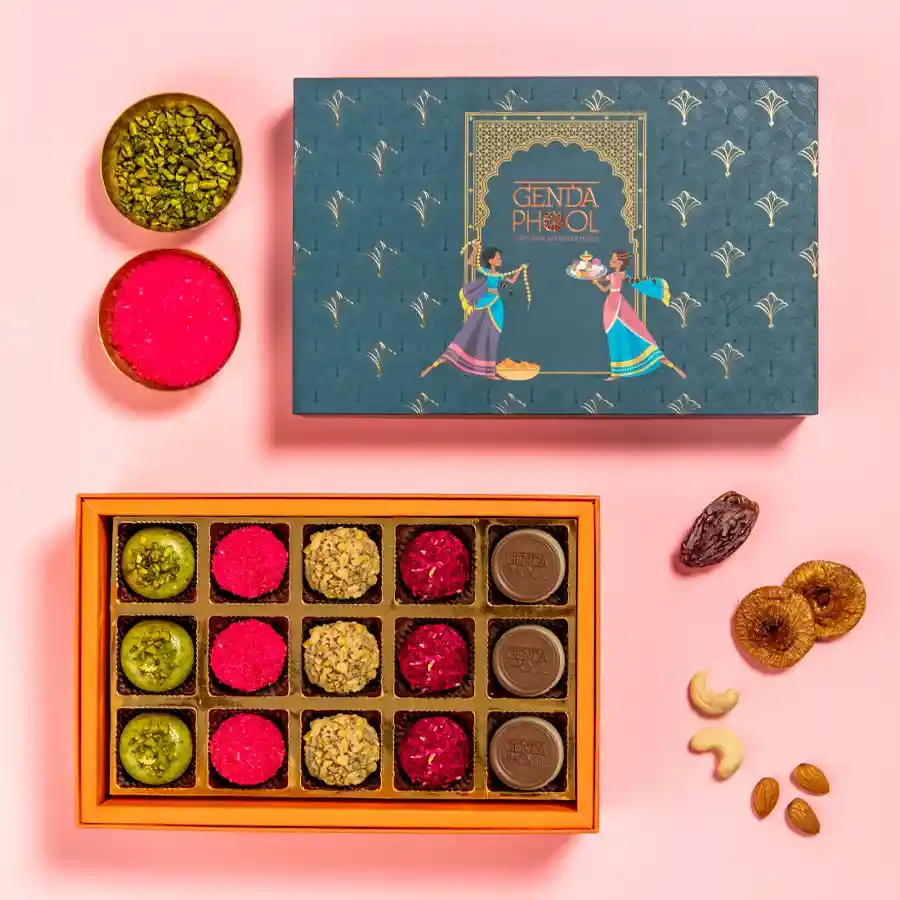 15 assorted mithai delicacies in a beautifully designed box, featuring Gud Pistachio, The Rosette, Earthy Bliss, Cashew Brew, and Nutty Royale.