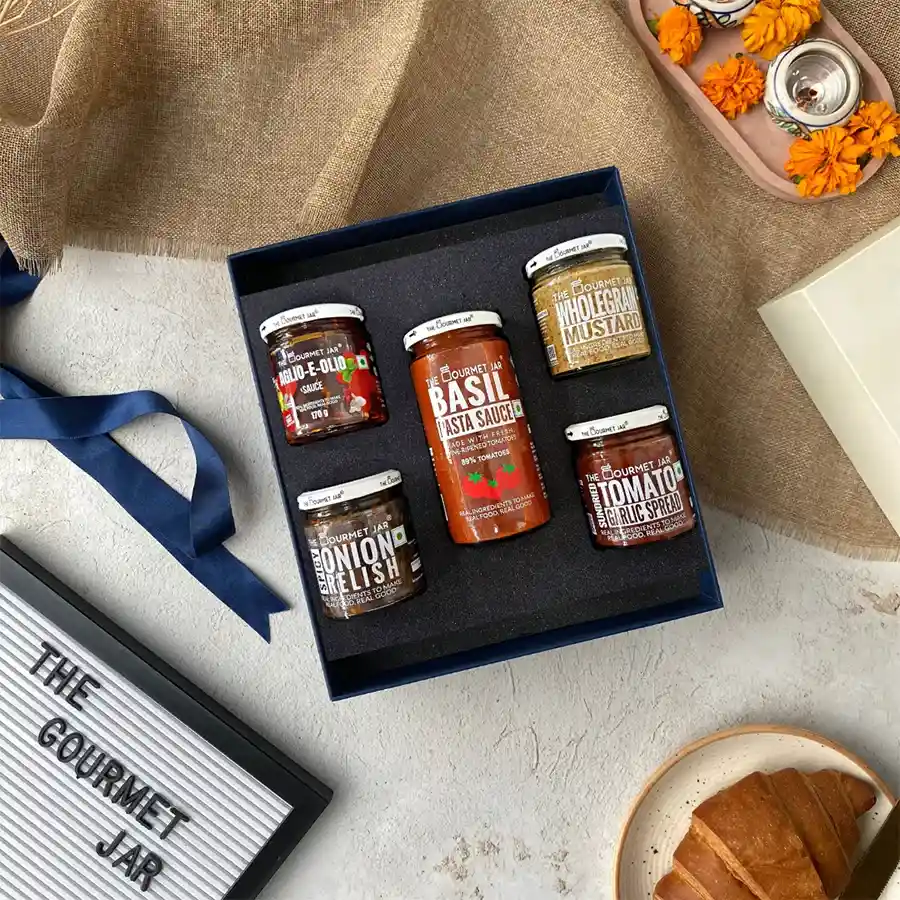 Gourmet Goodies for Food Lovers assortment featuring Basil Pasta Sauce, Aglio-E-Olio, Spicy Onion Relish, Sundried Tomato Garlic Spread, and Wholegrain Mustard.