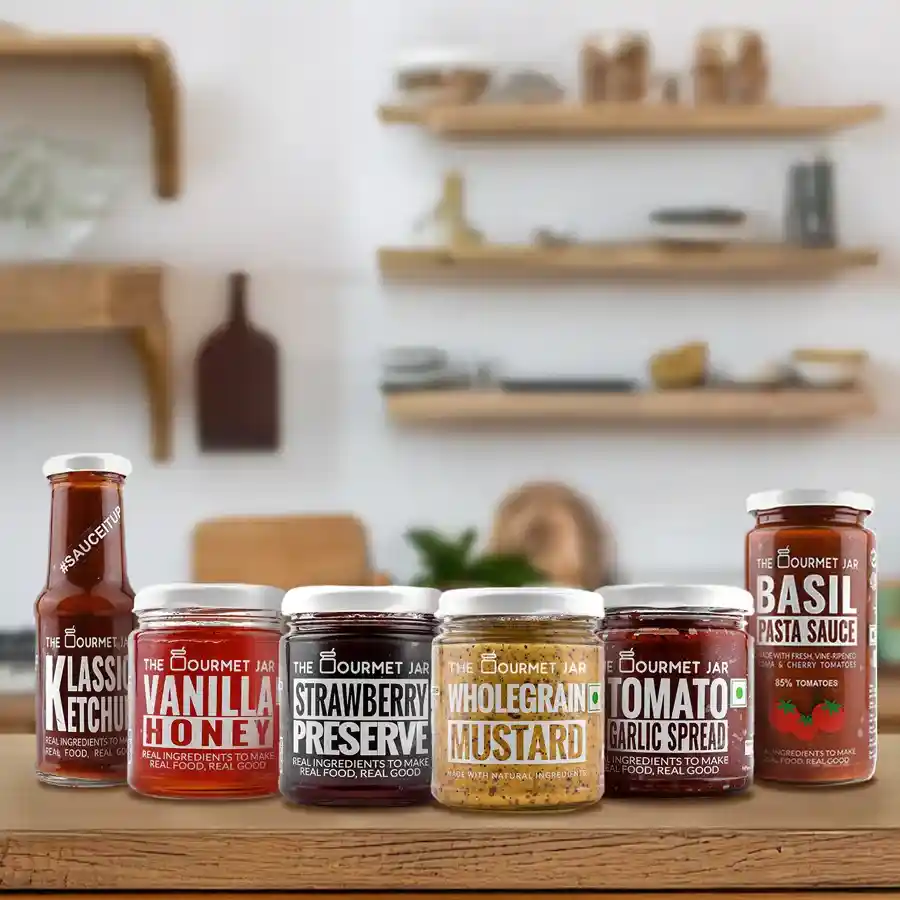 A gourmet collection featuring sauces and spreads including Strawberry Preserve, Wholegrain Mustard, Vanilla Honey, Sundried Tomato Garlic Spread, Basil Pasta Sauce, and Klassic Ketchup.