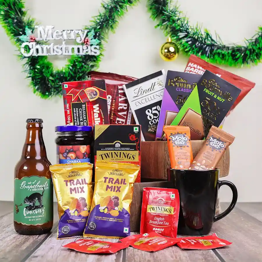 Festive Tea & Treats Delight Basket filled with gourmet snacks including tea, chocolate, and a reusable basket for the holiday season.