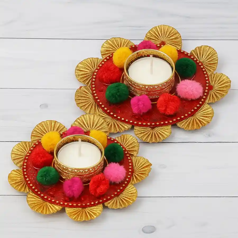 A dual set of vibrant flower design metallic diyas, crafted from cast iron, ideal for festive decor and gifting.