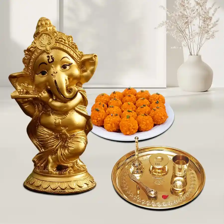 Ganesha Idol set featuring a golden idol, boondi ladoos, and a decorative Pooja Thali.