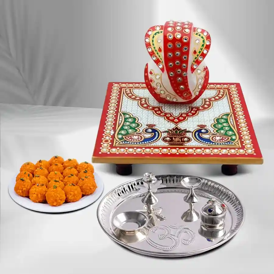 Divine Puja Celebration Gift Hamper featuring silver-plated thali, marble chowki, velvet asan, and sweets.