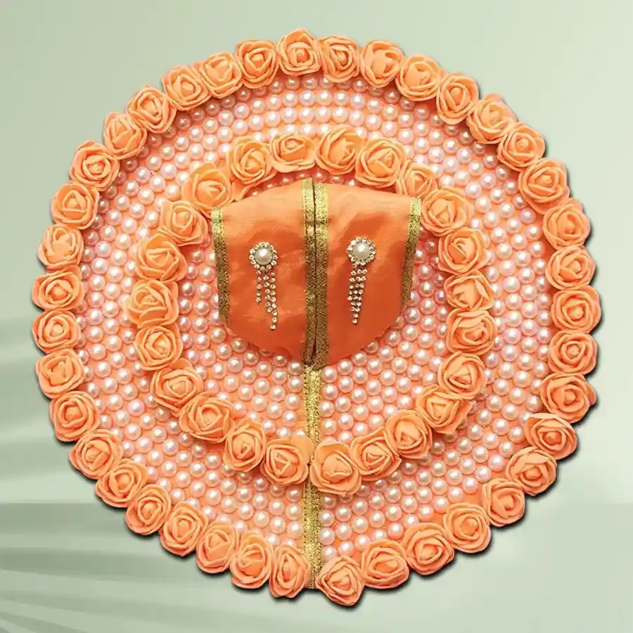 Handmade orange floral dress with a bansuri for Laddu Gopal.