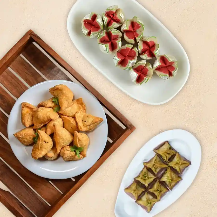 Pyramid Baklawa Celebration Trio from Haldirams, including baklawa, mini samosas, and Kaju Pista Flower sweets.