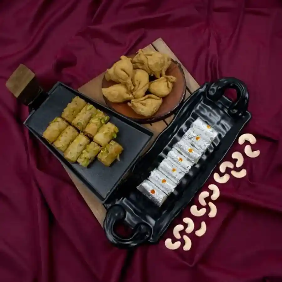 A delicious trio featuring Dunkel Braun's Roll Baklawa, Haldiram Mini Samosas, and Kaju Rolls, perfect for gifting and special occasions.