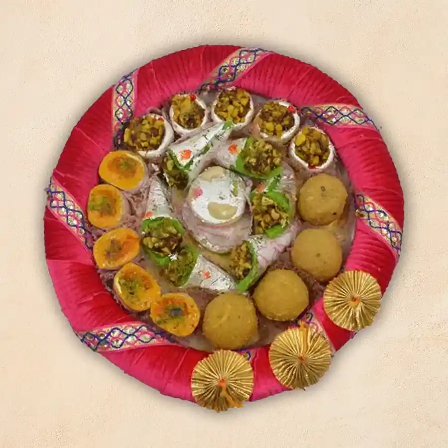 An enticing assortment of Indian sweets in the Dive In Sweet Platter, featuring Mawa Gilory, Besan Moong Laddoo, Kaju Katori, Kaju Pan, and Mawa Tikiya.