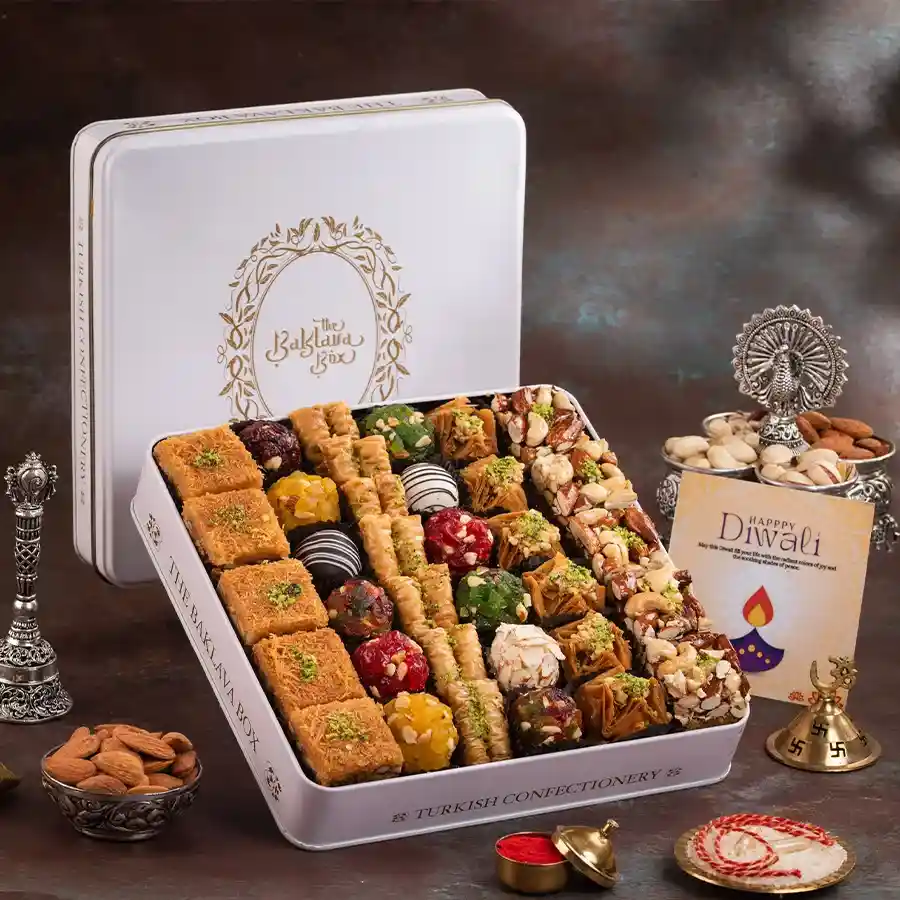 Elegant tin containing baklava and Indian fusion sweets, perfect for celebrations.