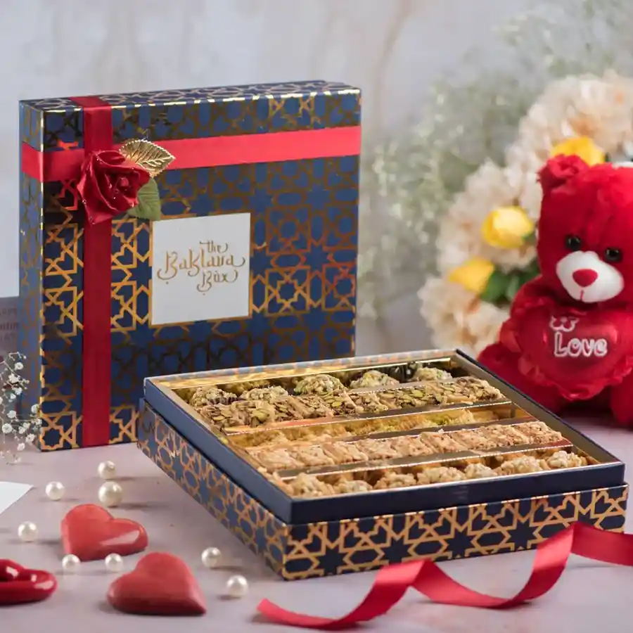 Luxurious velvet box containing baklava treats and a customized card.
