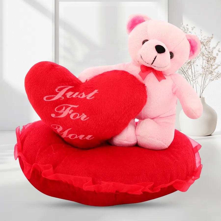 Love Nest Cushion featuring a Teddy Bear on a red pillow with a heart token, perfect for gifting love and affection.