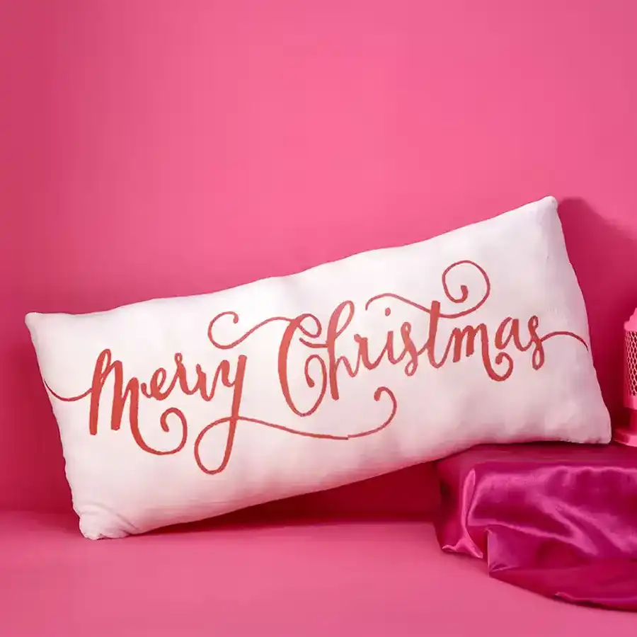 Cozy Christmas Soft Santa Pillow, perfect for festive decor and cuddling. Measures 21 by 10 inches with a cheerful "Merry Christmas" design.