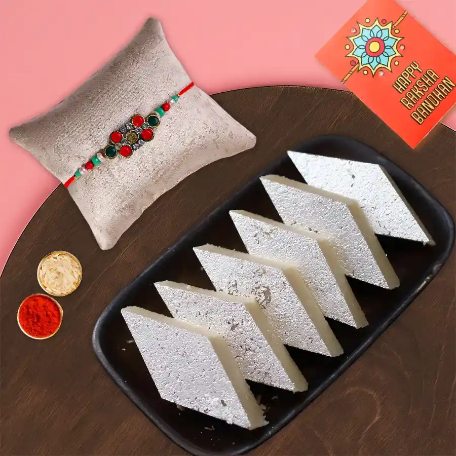 Haldiram Badam Katli 250g pack with a designer Rakhi, Roli Tilak, and Chawal for Rakshabandhan celebration.