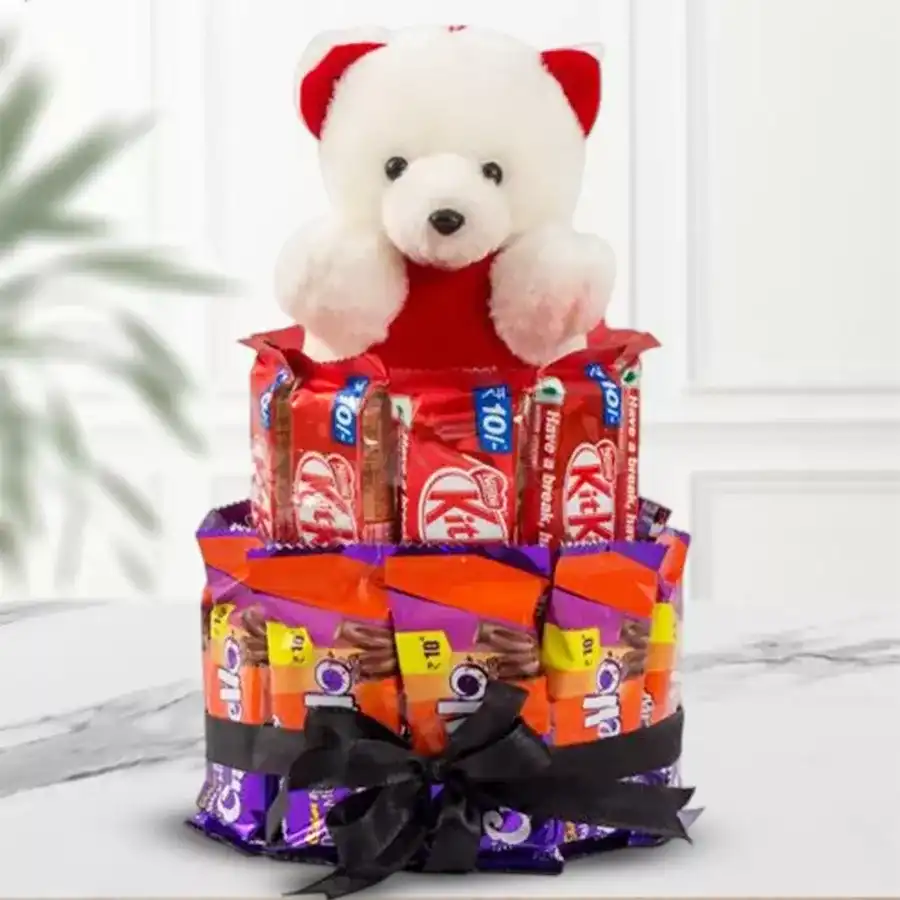 Adorable teddy bear paired with chocolates in a delightful arrangement.