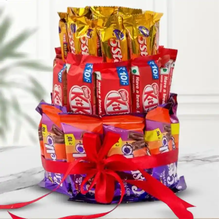 Three-layer chocolate arrangement featuring Kitkat, 5 Star, and Crispello, elegantly tied with a red ribbon.