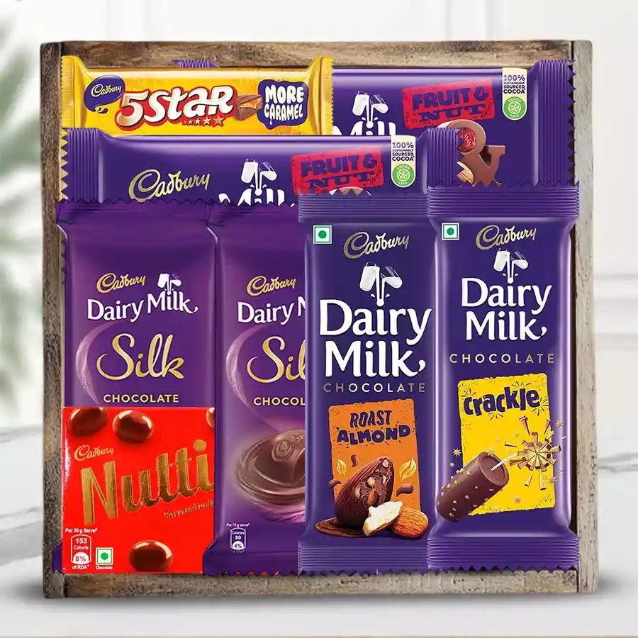 Assorted Cadbury chocolate gift tray featuring various chocolates arranged in a stylish wooden tray.