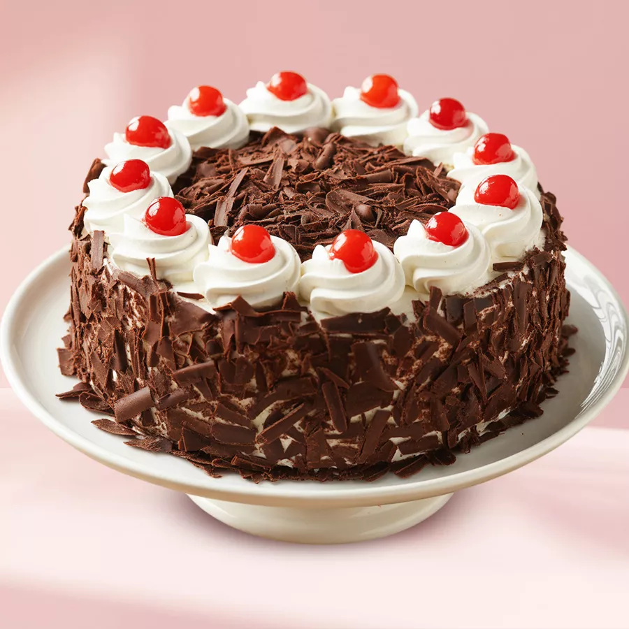 A beautifully crafted 1/2 kg Black Forest Cake, perfect for Mother's Day, featuring chocolate layers and cherries.