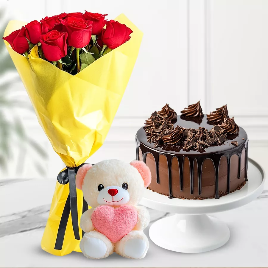 Chocolate cake, red rose bouquet, and a small teddy bear gift combo.