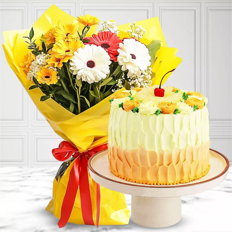 Tropical pineapple cake paired with a vibrant bouquet of mixed flowers for celebrations.