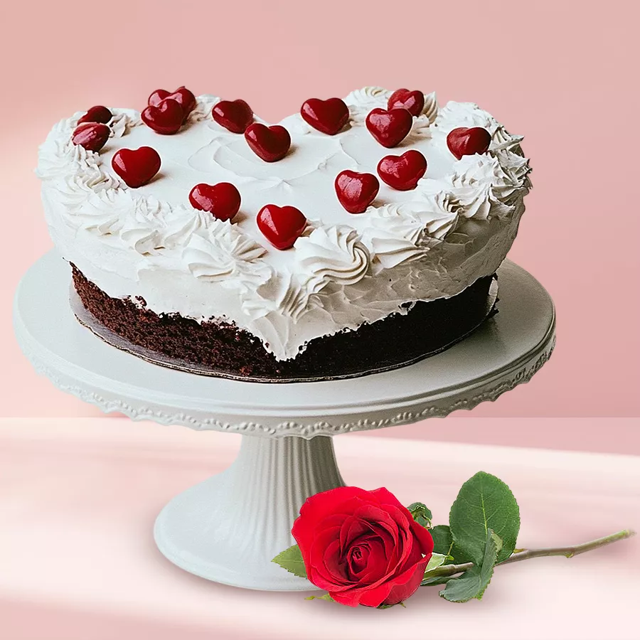 Heart-shaped Black Forest cake paired with a single red rose.