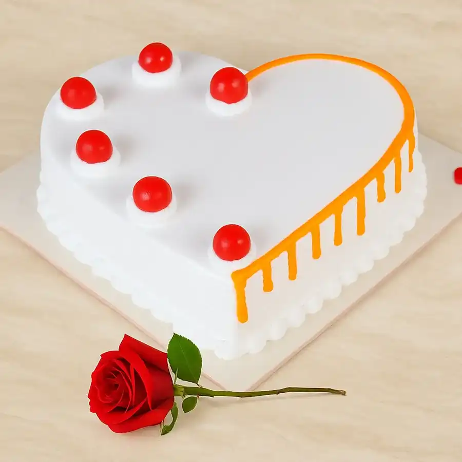 Heart-shaped vanilla cake with a red rose, weighing 1 kg.