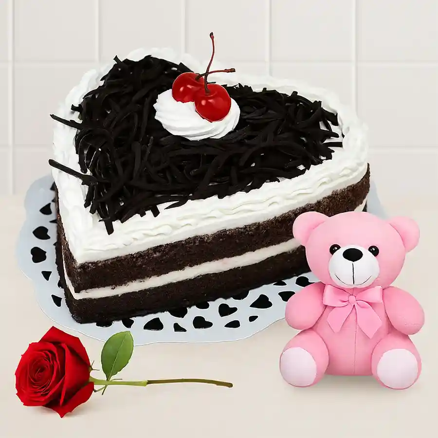 Heart-shaped Black Forest cake, red rose, and teddy bear combo gift.