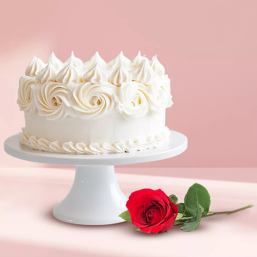 Eggless vanilla cake with a single rose, perfect gift pairing.