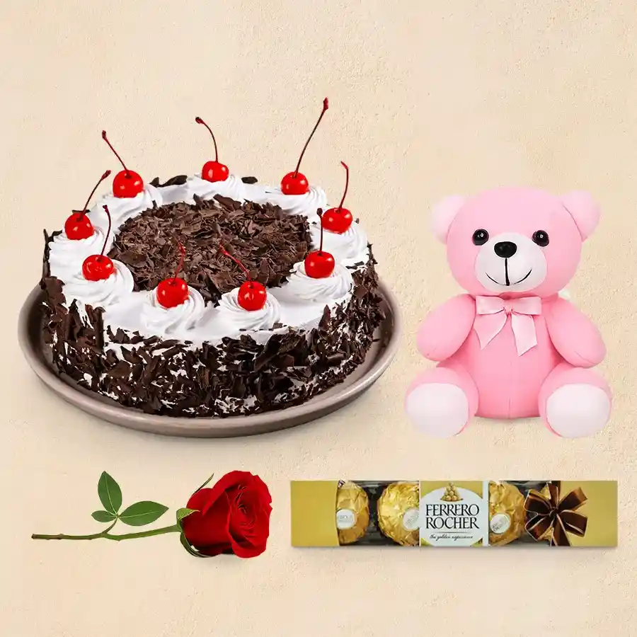Enchanting red rose, Ferrero Rocher chocolates, teddy bear, and eggless Black Forest cake gift set.