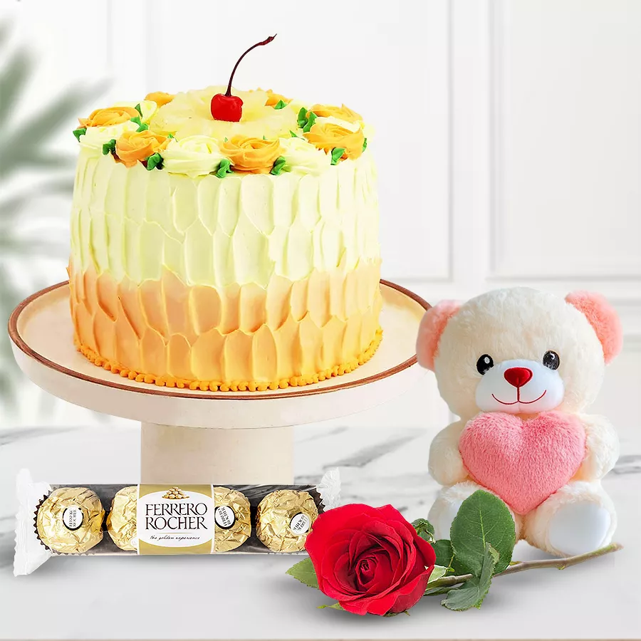 Butterscotch cake with a rose, teddy bear, and Ferrero Rocher chocolates.