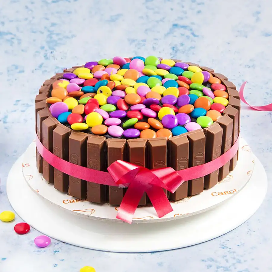 A beautifully decorated 1 lb KitKat Gems Cake for Christmas celebrations.