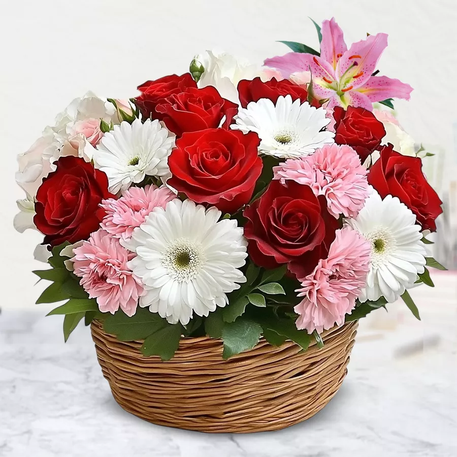 A vibrant basket of assorted flowers with colorful balloons, perfect for celebrations.