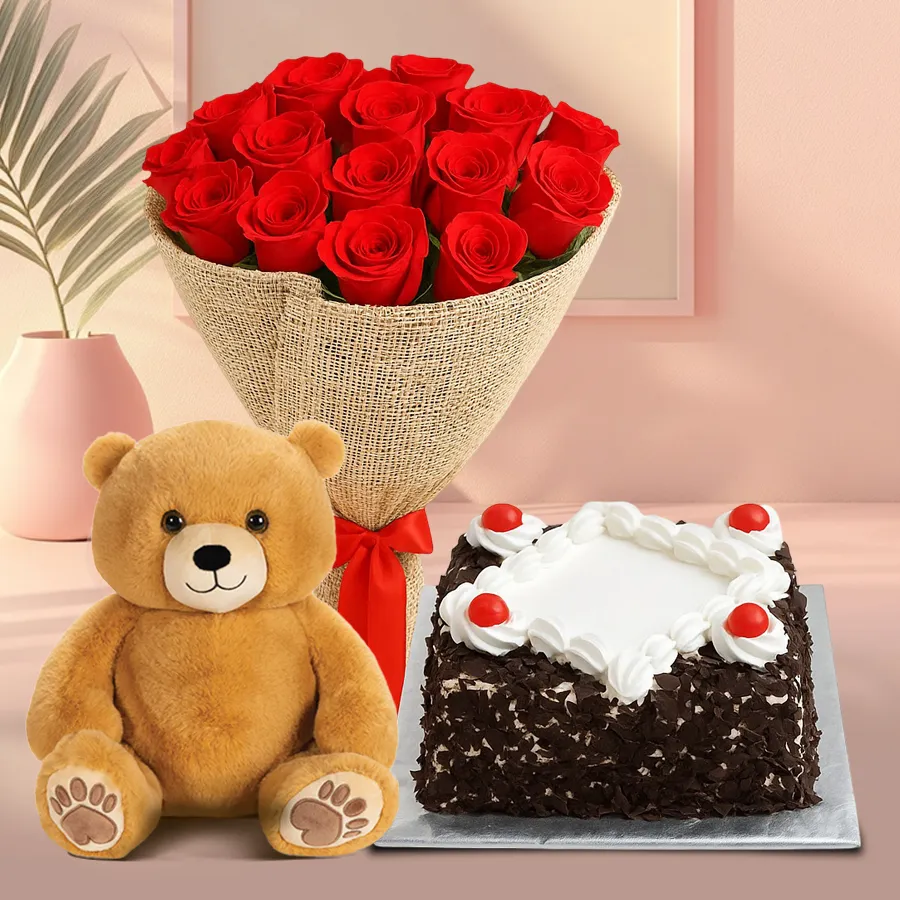 A delicious Black Forest cake with a bouquet of 10 red roses and a small teddy bear for gifting.