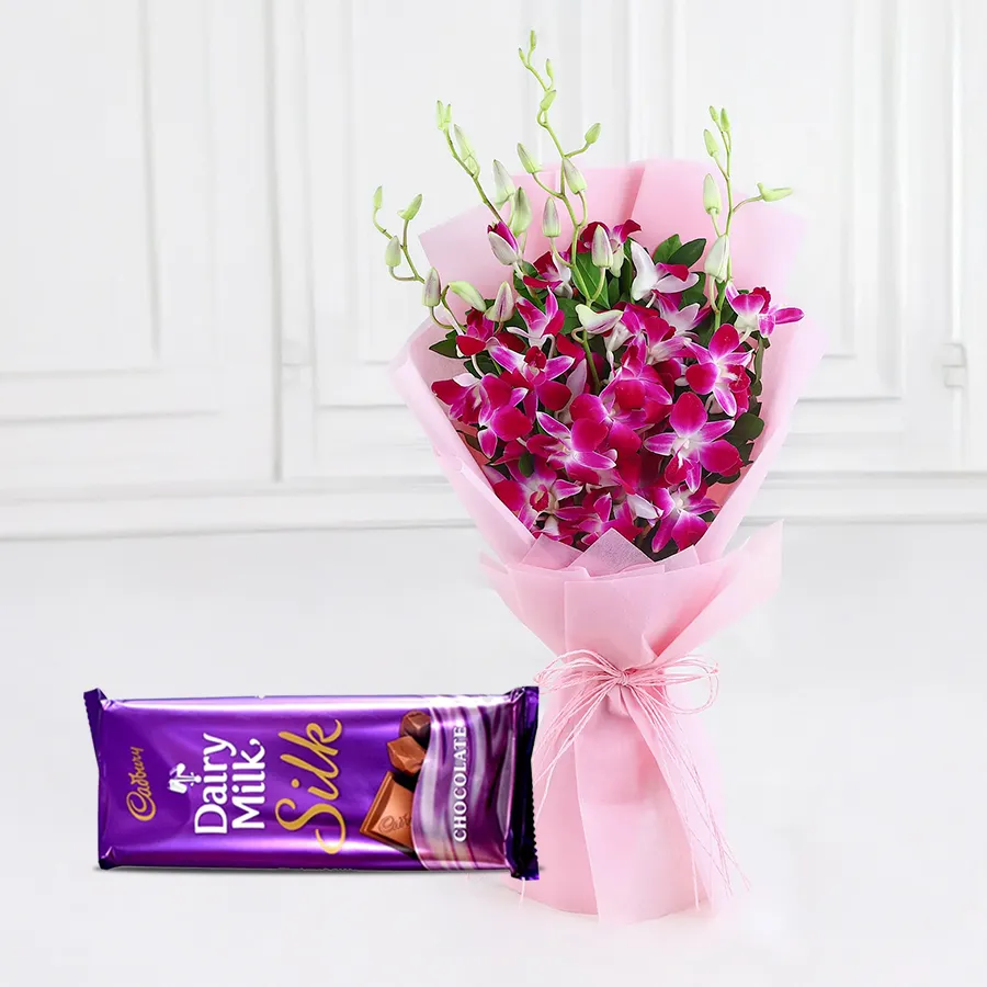 Bouquet of six orchids with a bar of Cadbury Dairy Milk Silk.