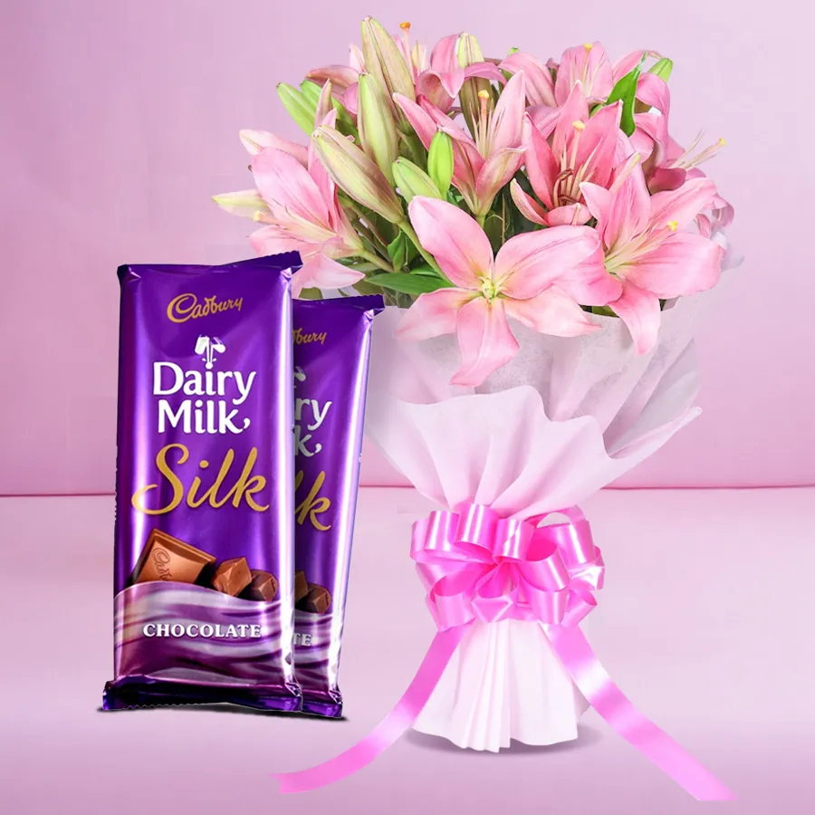 Bouquet of pink lilies with two Dairy Milk Silk chocolates for an anniversary gift.