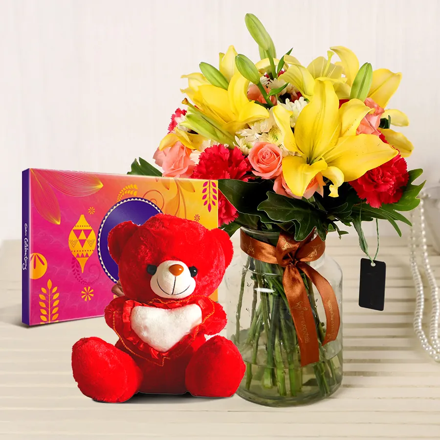 Joyful Blossoms and Treats Delight featuring mixed flowers, Cadbury chocolates, and a small teddy bear.