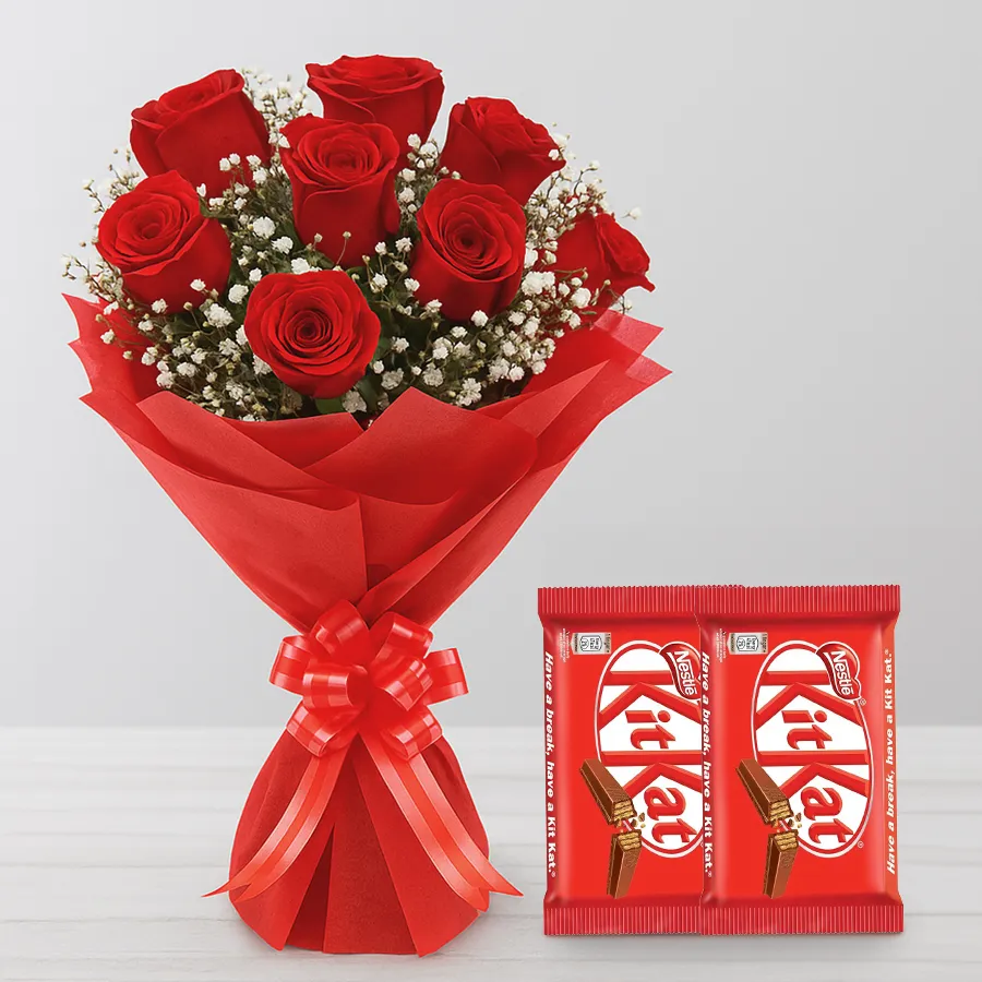 A beautiful bouquet of red roses alongside Nestle Kit Kat chocolate bars, perfect for gifting.