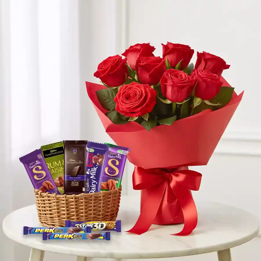 Gift basket filled with Cadbury chocolates and a bouquet of red roses.