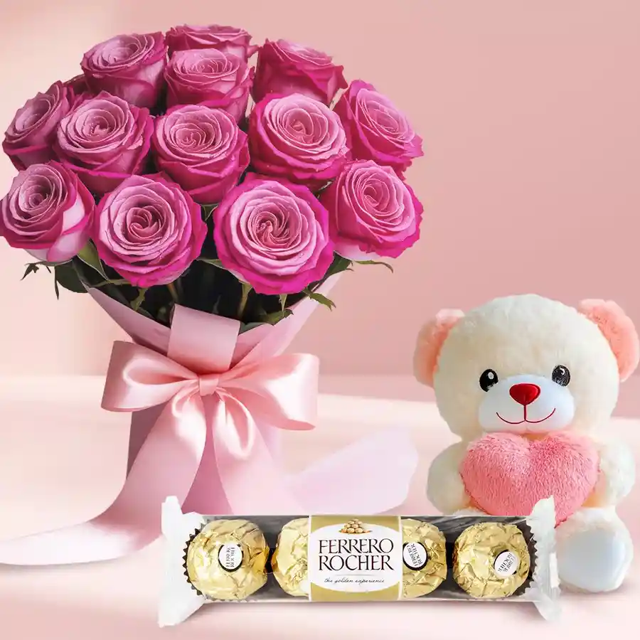 A charming gift set featuring Ferrero Rocher chocolates, pink roses, and a cute teddy bear, ideal for expressing love and affection.