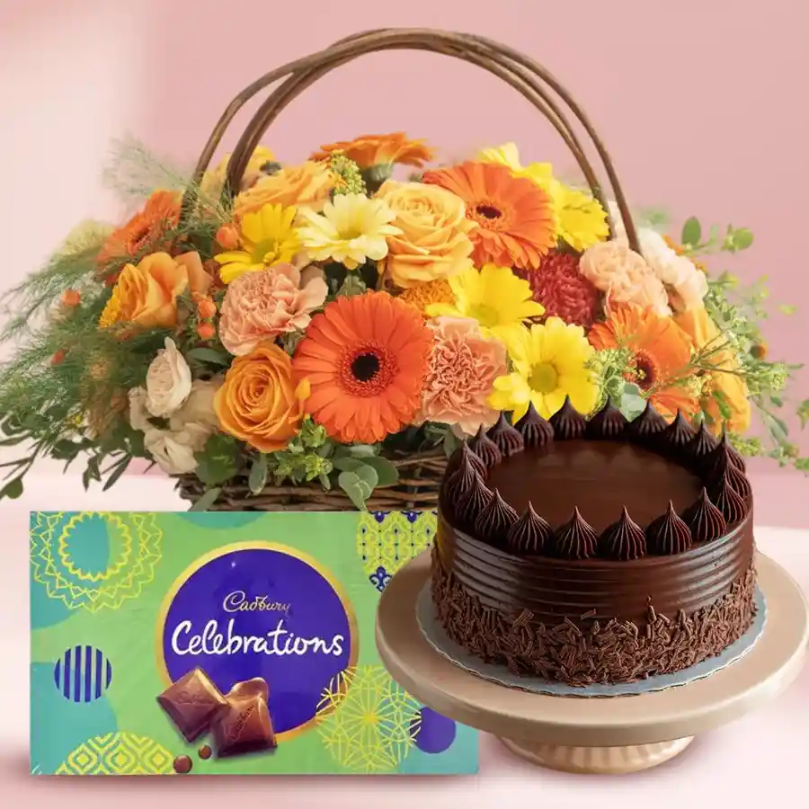 A delightful basket featuring a chocolate cake, Cadbury Celebrations, and seasonal flowers, perfect for gifting.