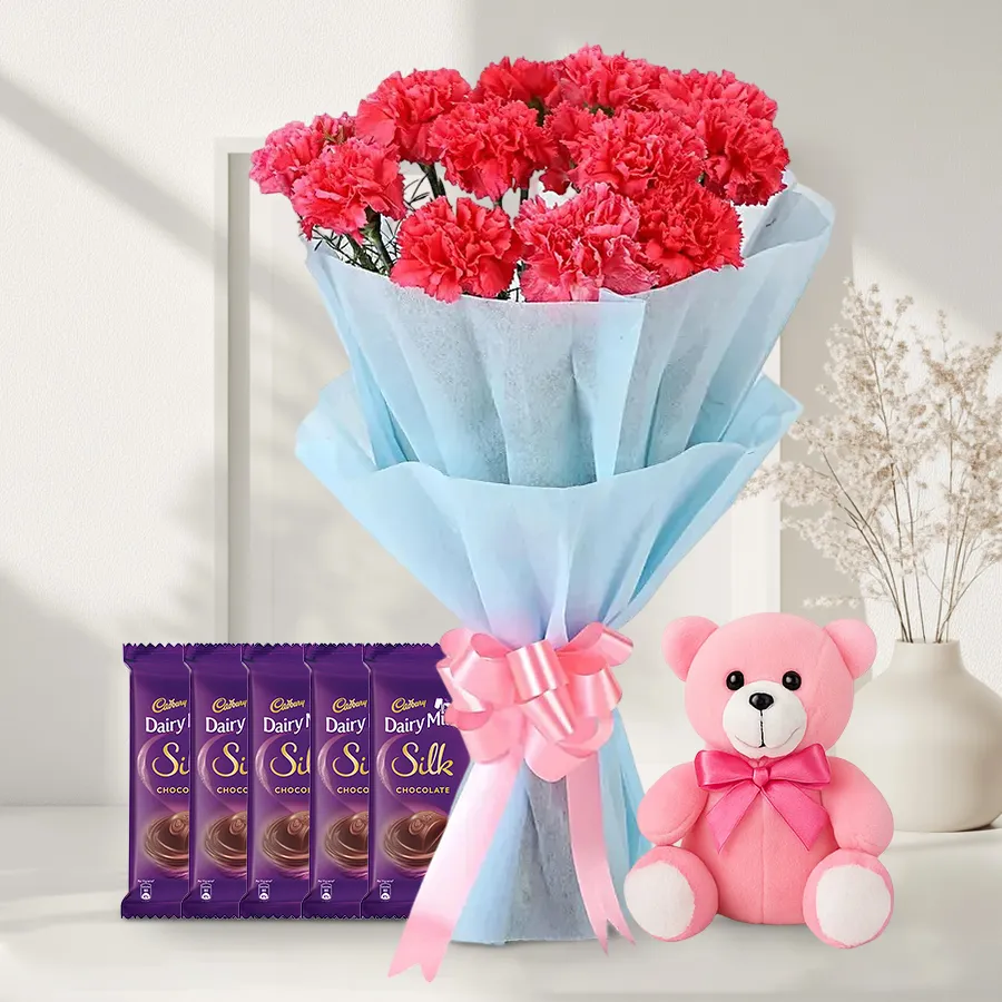 A charming gift set featuring pink carnations, Cadbury chocolates, and a teddy bear. Perfect for expressing love and affection.