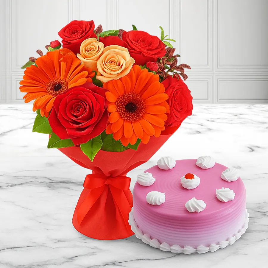 A gorgeous arrangement of assorted flowers and a delicious strawberry cake, ideal for celebrating anniversaries.