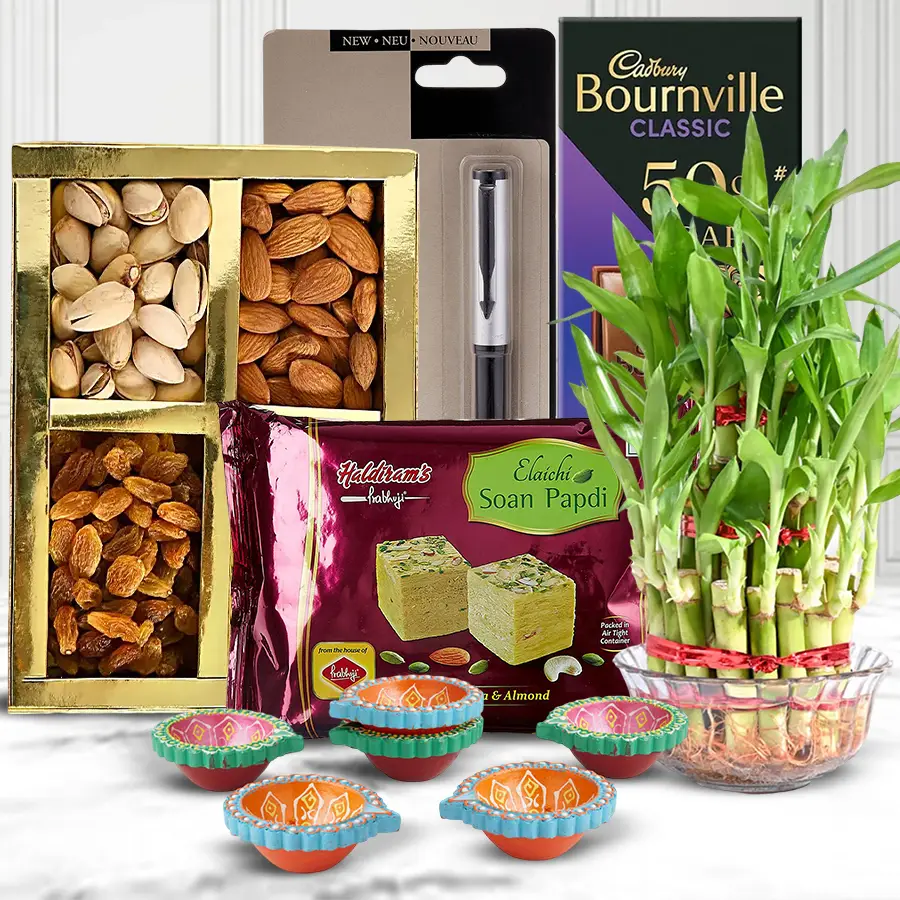A beautifully curated Eco-Conscious Diwali Gift Collection featuring a Parker pen, chocolate, bamboo plant, sweets, dry fruits, and mud diyas.