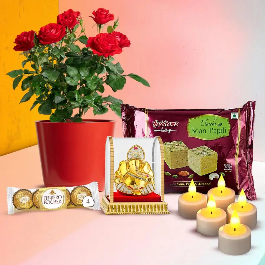 A vibrant red rose plant, Vignesh Ganesh idol, Ferrero Rocher chocolates, Soan Papdi, and LED candles in a festive Diwali gift combo.