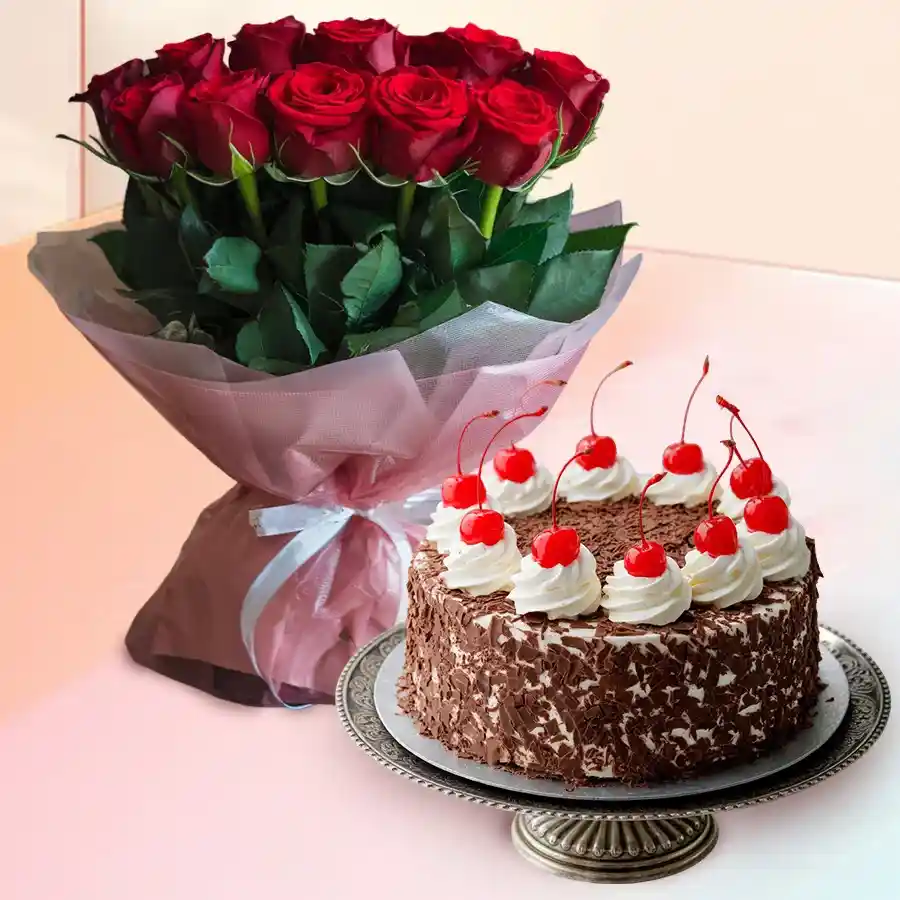 A beautiful bouquet of 12 red Dutch roses accompanied by a round Black Forest cake, ideal for celebrating special occasions.